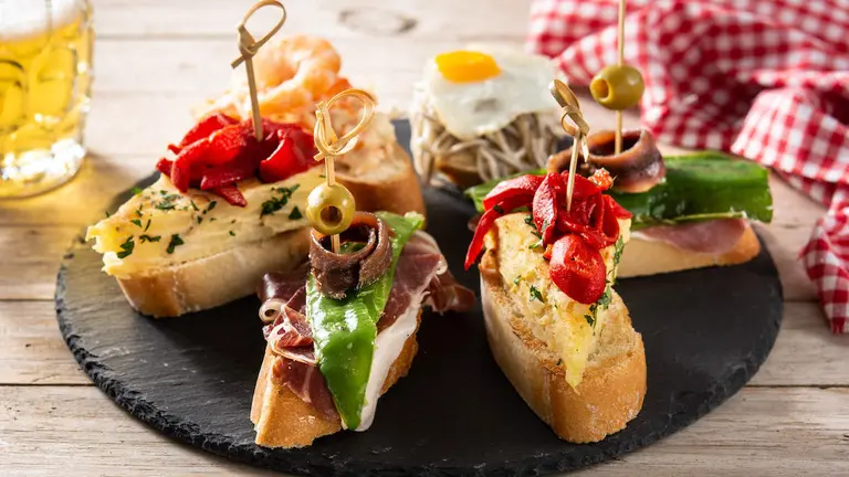 Assortment of Spanish pintxos on wooden table